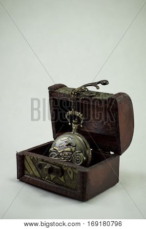 Clock perfectly complement a small chest on the light background.