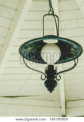 Retro lamp in the gazebo by the sea.
