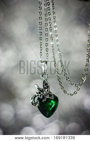 Abstract photo jewelry pendant with green crystal.