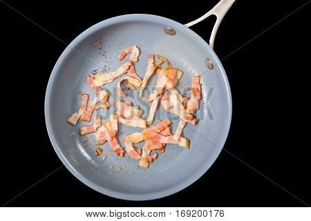 Bacon for pasta Carbonara fried in a pan. Isolated.