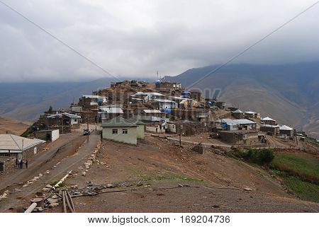 Xinaliq, Azerbaijan - August 23, 2014. Xinaliq mountainous village in Azerbaijan, with residential houses, car and people