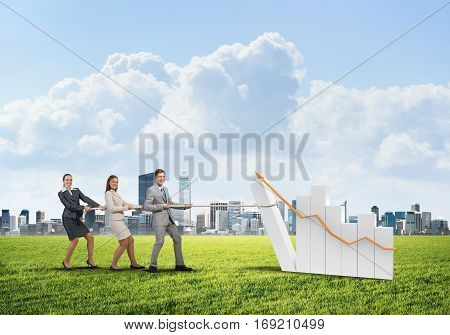 Young business people pulling up graph bar using rope