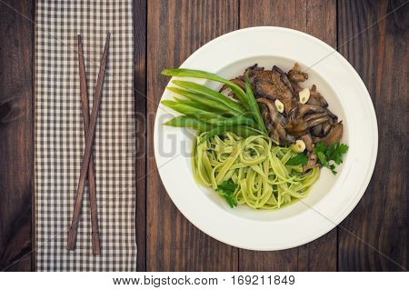 Plate Of Spaghetti Dough With Spinach And Oyster Mushrooms. Italian Cuisine, Italian Recipes. Wooden