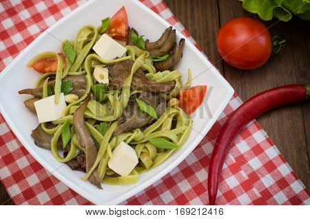 Plate Of Spaghetti Dough With Spinach And Oyster Mushrooms. Italian Cuisine, Italian Recipes. Wooden
