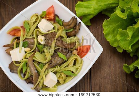 Plate Of Spaghetti Dough With Spinach And Oyster Mushrooms. Italian Cuisine, Italian Recipes. Wooden