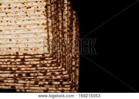 Traditional Jewish matzah on a black background. Close-up