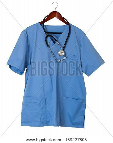 Blue medical scrubs uniform shirt hanging on a hanger with stethoscope and isolated against white background