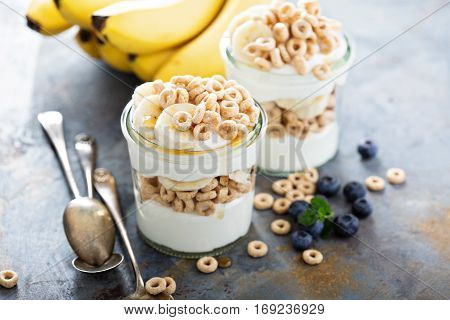 Yogurt parfait with cereal, banana and maple syrup