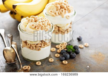 Yogurt parfait with cereal, banana and maple syrup