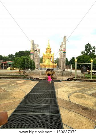 girl was running at behind Buddha statue