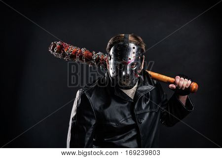 Bloody maniac in mask and black leather coat