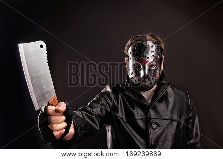Murderer in hockey mask with meat cleaver in hand