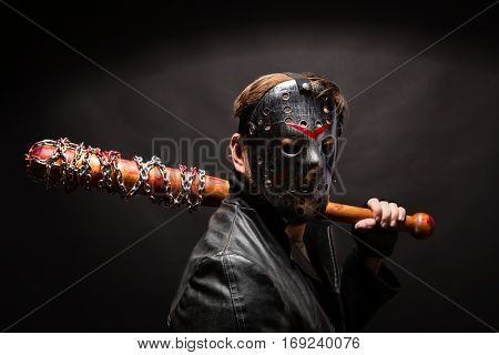 Bloody maniac in mask and black leather coat