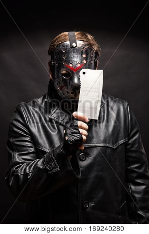 Serial murderer with knife on black background.