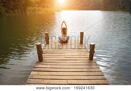Woman do yoga outdoor. Woman exercising yoga at the nature background select focus