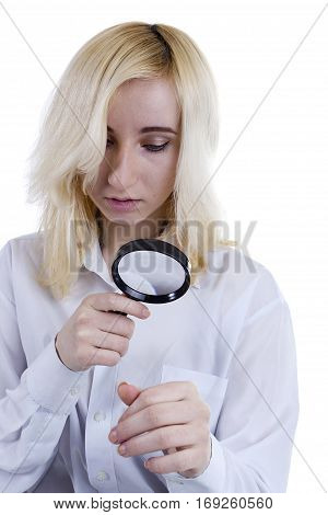 Portrait of beautiful young woman with magnifier glass