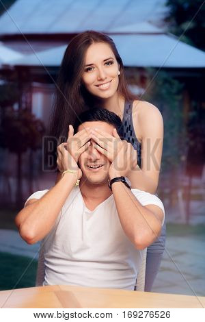 Woman Covering Man's Eyes Taking him by Surprise on a Blind Date