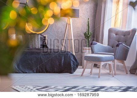 Bedroom With Armchair And Footstool