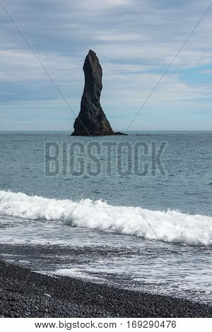 Reynisdrandar basalt sea stack near the village Vik i Myrdal
