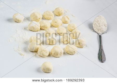Raw dumplings with cottage cheese on the table