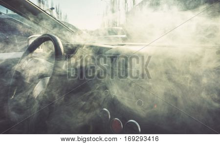Car interior in smoke or vapour. Vape Inside car. Can be used as fire in automobile