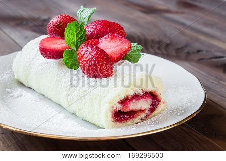 Homemade Sweet roll with Strawberry jam and berries on wooden background