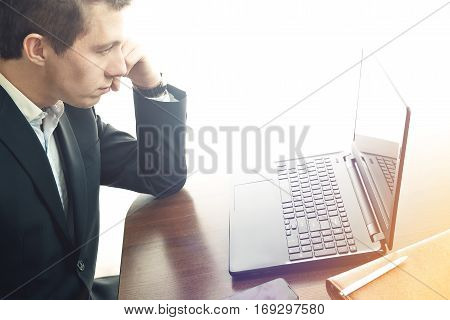 business man working at office with laptop on his desk