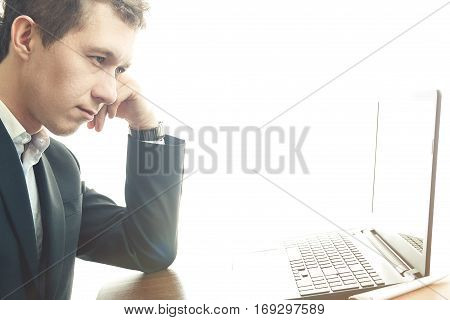 business man working at office with laptop on his desk