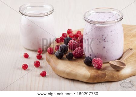 Smoothies with frozen berries red currants black currants and raspberries in two banks