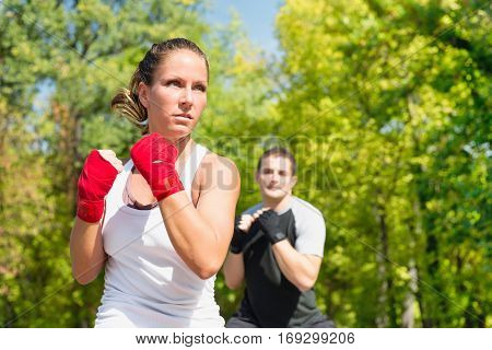 TaeBo training outdoors, in park, toned image