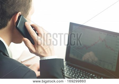 business man working at office with laptop on his desk. He calling