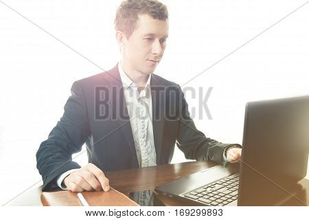 business man working at office with laptop on his desk