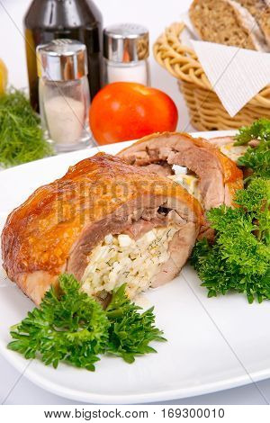 Stuffed turkey thigh with rice and egg on a white plate