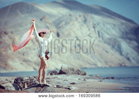 Happy woman enjoying beach relaxing joyful in summer by tropical blue water.