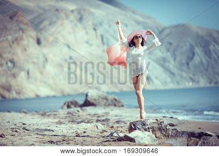 Happy woman enjoying beach relaxing joyful in summer by tropical blue water.