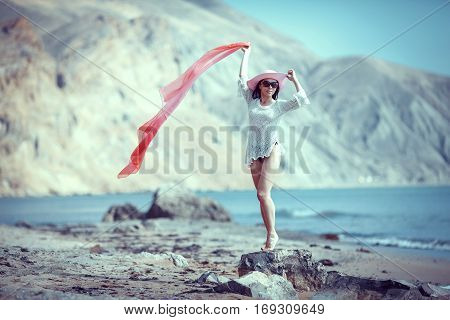 Happy woman enjoying beach relaxing joyful in summer by tropical blue water.