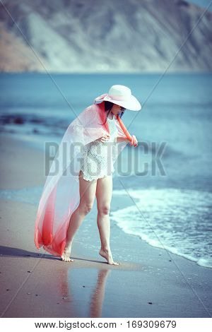 Happy woman enjoying beach relaxing joyful in summer by tropical blue water.