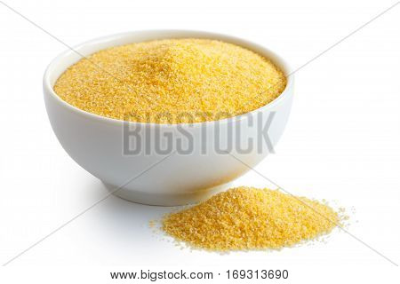 Cornmeal Polenta In White Ceramic Bowl Isolated On White. Spilled Cornmeal.