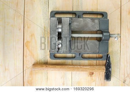 The vise to clamp on a wooden desktop environment tools.