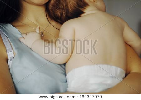 little baby asleep in the arms of his mother. small child's hand