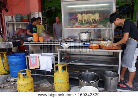 Unidentified Vendor Prepares Steam Chicken On His Stall