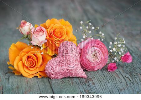 Stil life with colorful roses on an old shabby wooden table for a mothers day greeting card