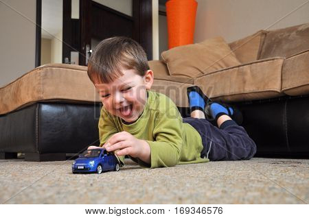 Happy kid play with his car toy