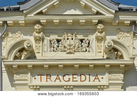 Theater building detail with tragedia inscription on the wall