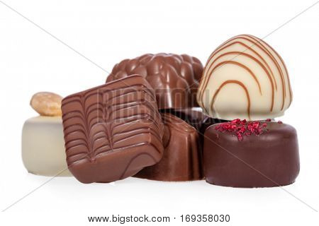 Gourmet bonbons, aka bon-bons and truffles made of dark, white and milk chocolate isolated on white background
