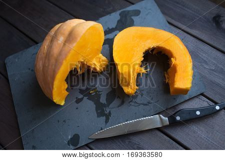 chopped pumpkin on a dark wooden table