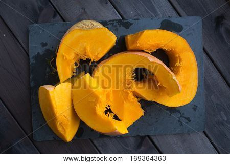 chopped pumpkin on a dark wooden table