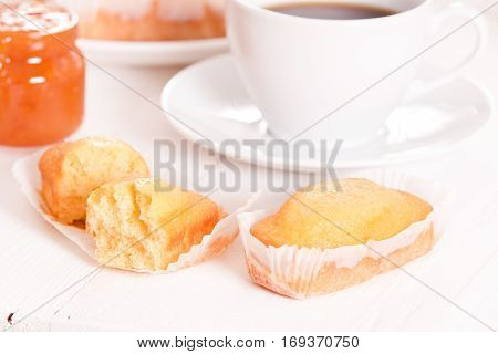 Breakfast with plumcake and apricot jam on wooden table.