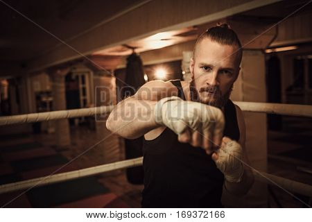 Fighter shadowboxing on training ring