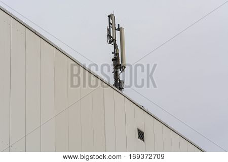 Antenna telecommunications tower on a roof wireless telecommunications concept.